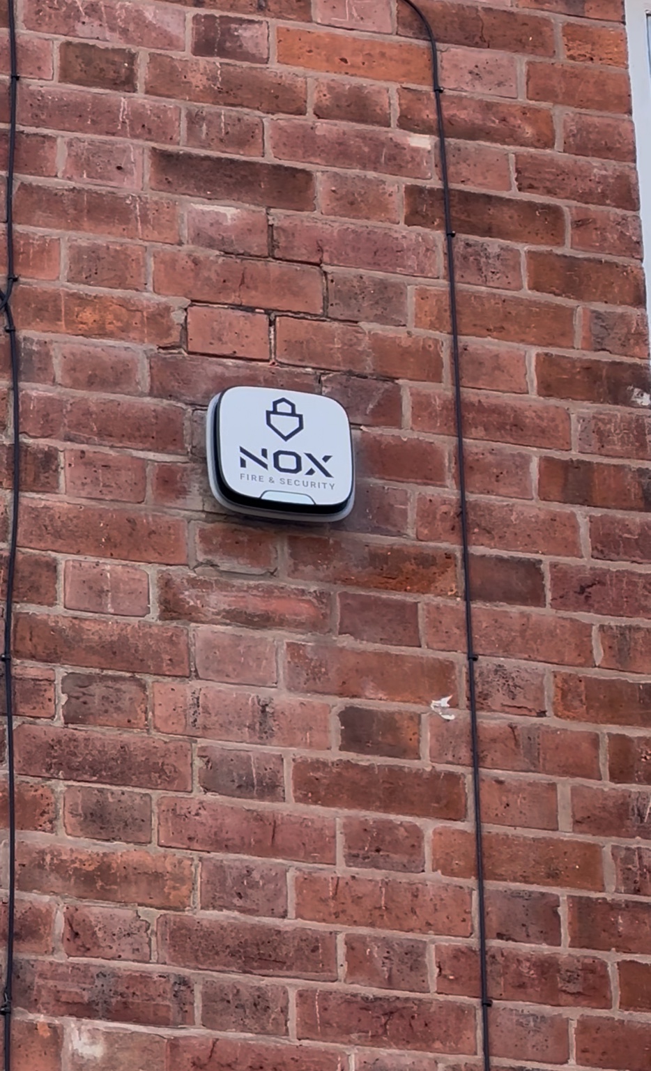 NOX branded external alarm warning device on a Chesterfield home