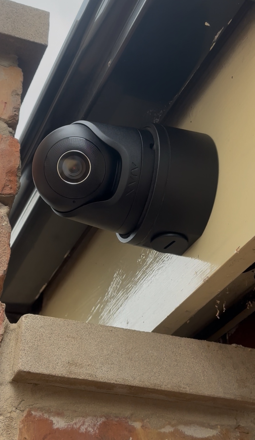 Black Ajax-style CCTV camera installed beneath the roofline