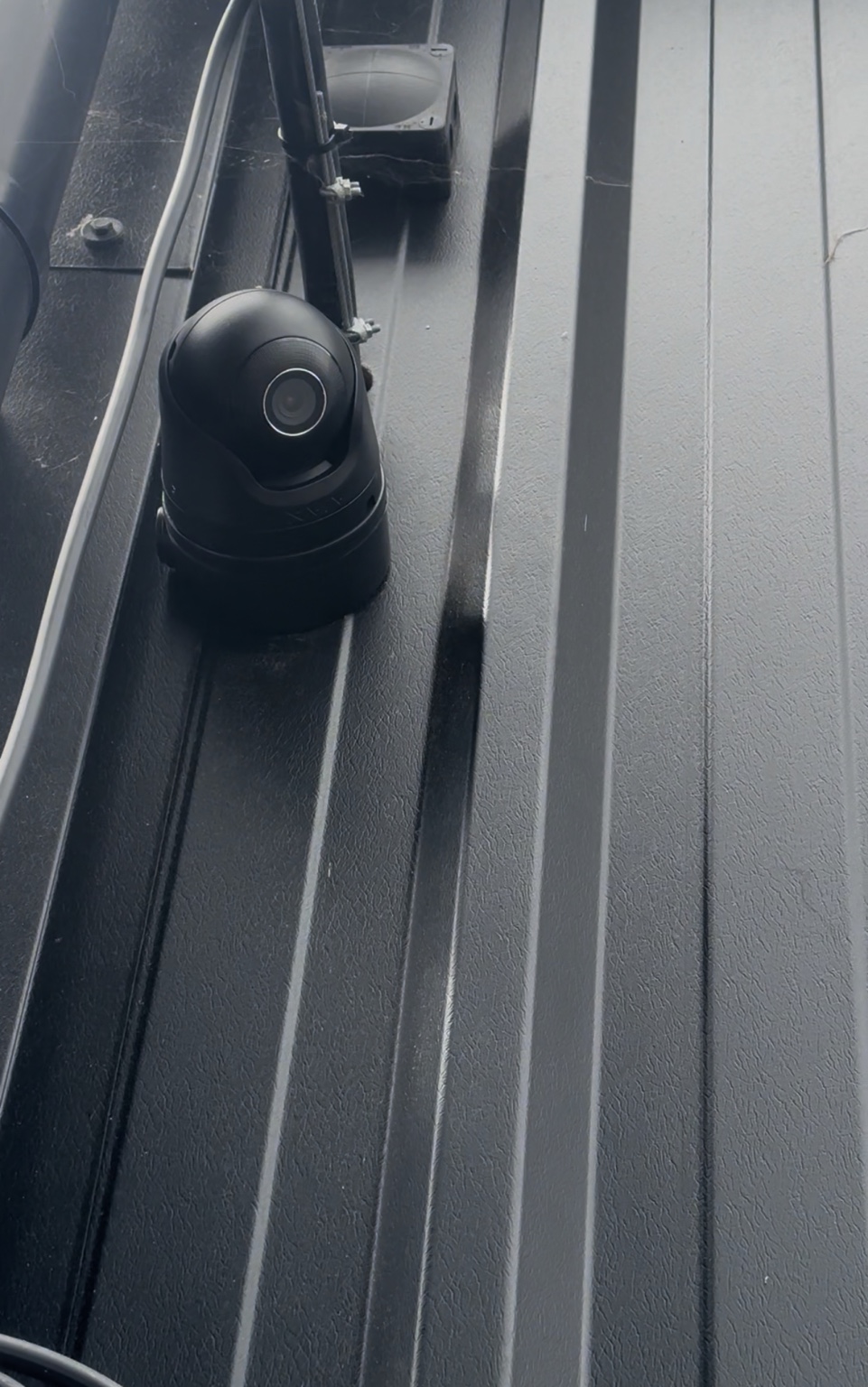 Commercial CCTV camera installed on the black exterior of The Tan Station