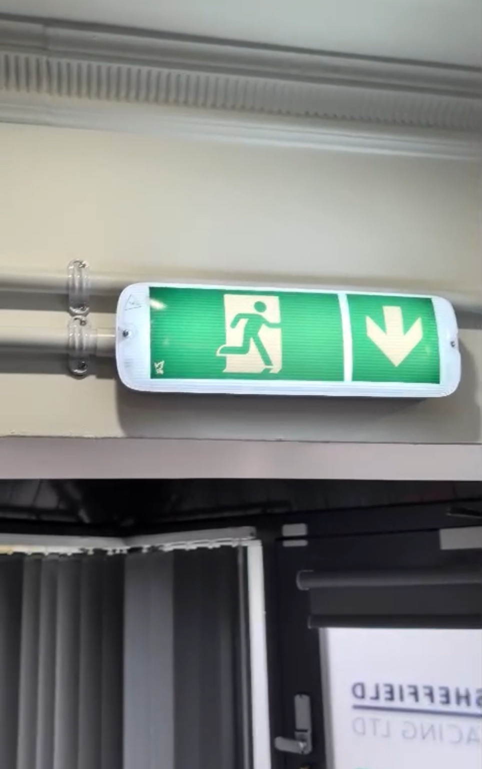 Emergency exit light checked during commercial testing and servicing