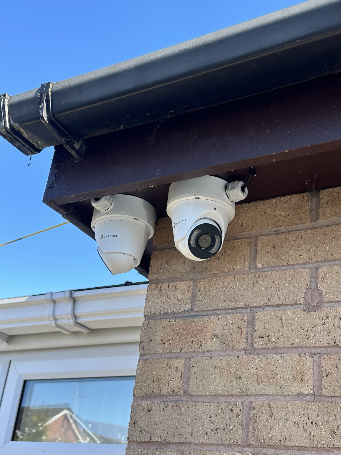 Two professional residential CCTV cameras installed by NOX beneath a roofline